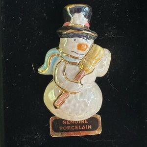 Porcelain snowman pin.